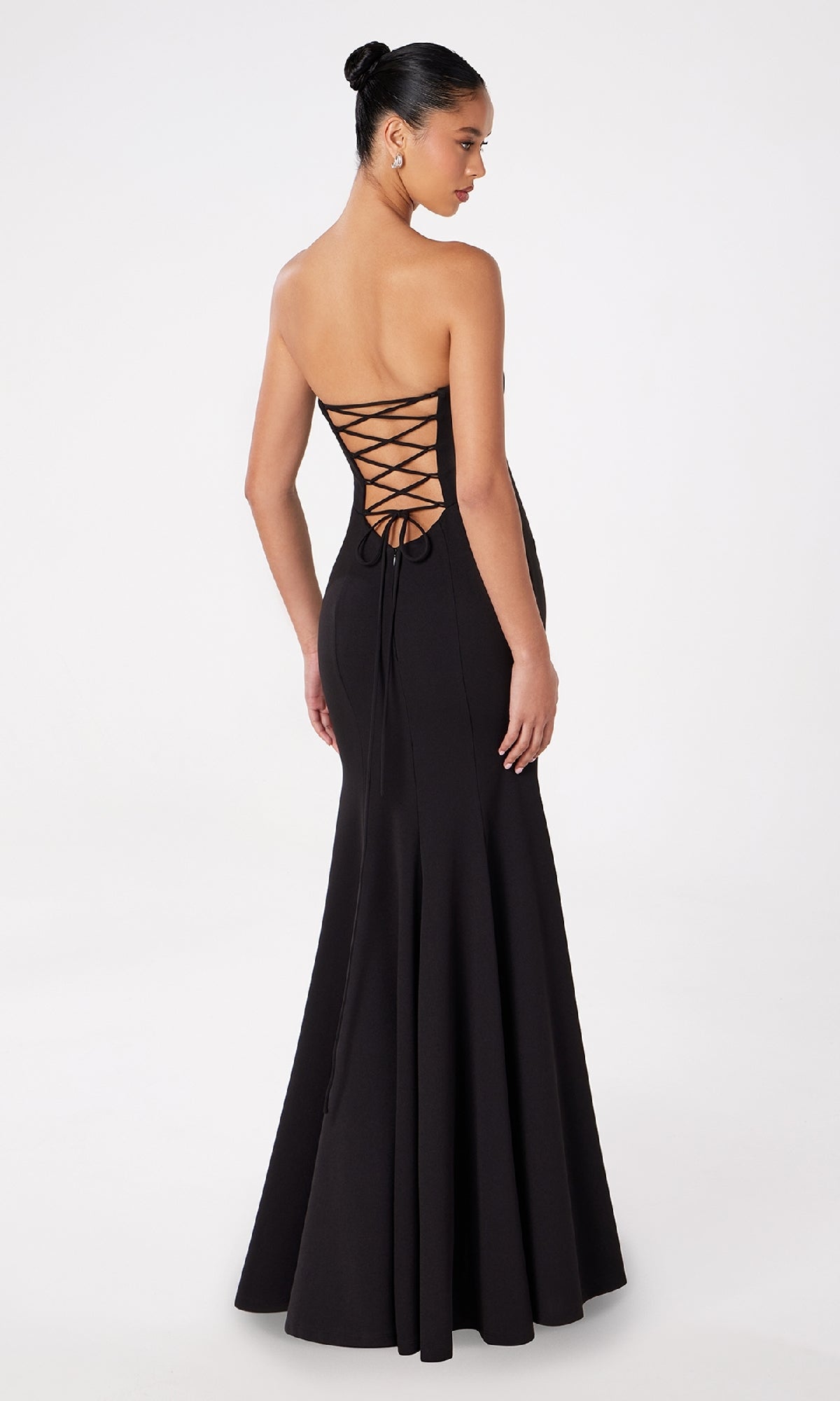 A woman models the Lace-Up Strapless Long Prom Dress: Astee T2010, featuring a floor-length silhouette and open lace-up back, set against a plain white background.